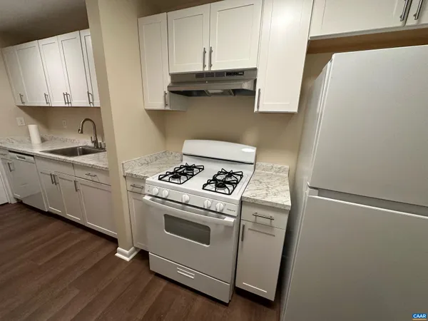 a kitchen with stainless steel appliances white cabinets and a stove