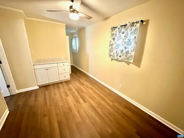 a view of room with wooden floor