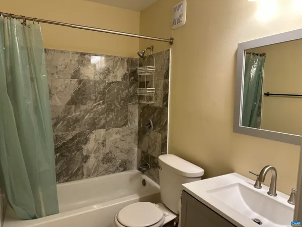 a bathroom with a toilet and a bathtub