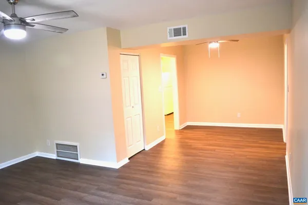 a view of empty room with wooden floor
