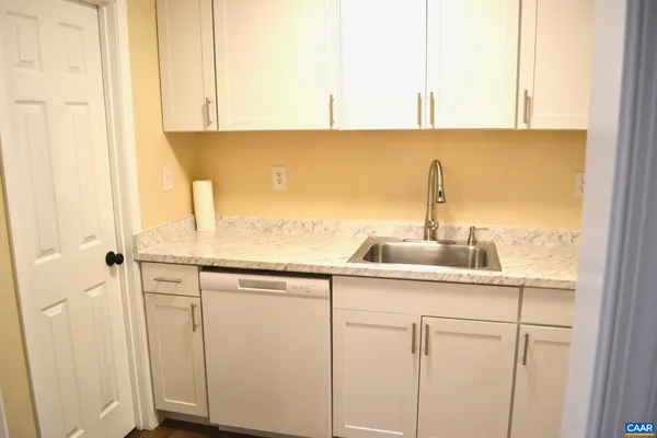 a kitchen with a sink and cabinets