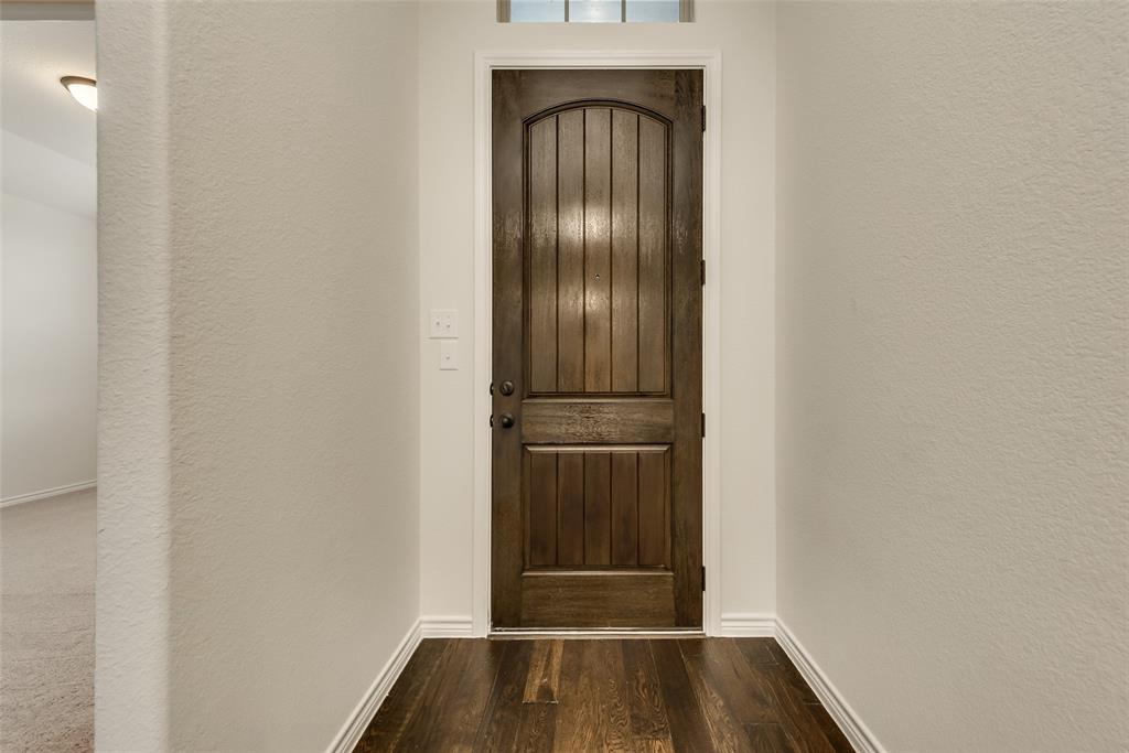 a view of front door with wooden floor