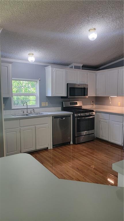 174 Luther Circle Villa Rica, GA 30180 - Photo 8 of 32 a kitchen with granite countertop a sink cabinets and stainless steel appliances