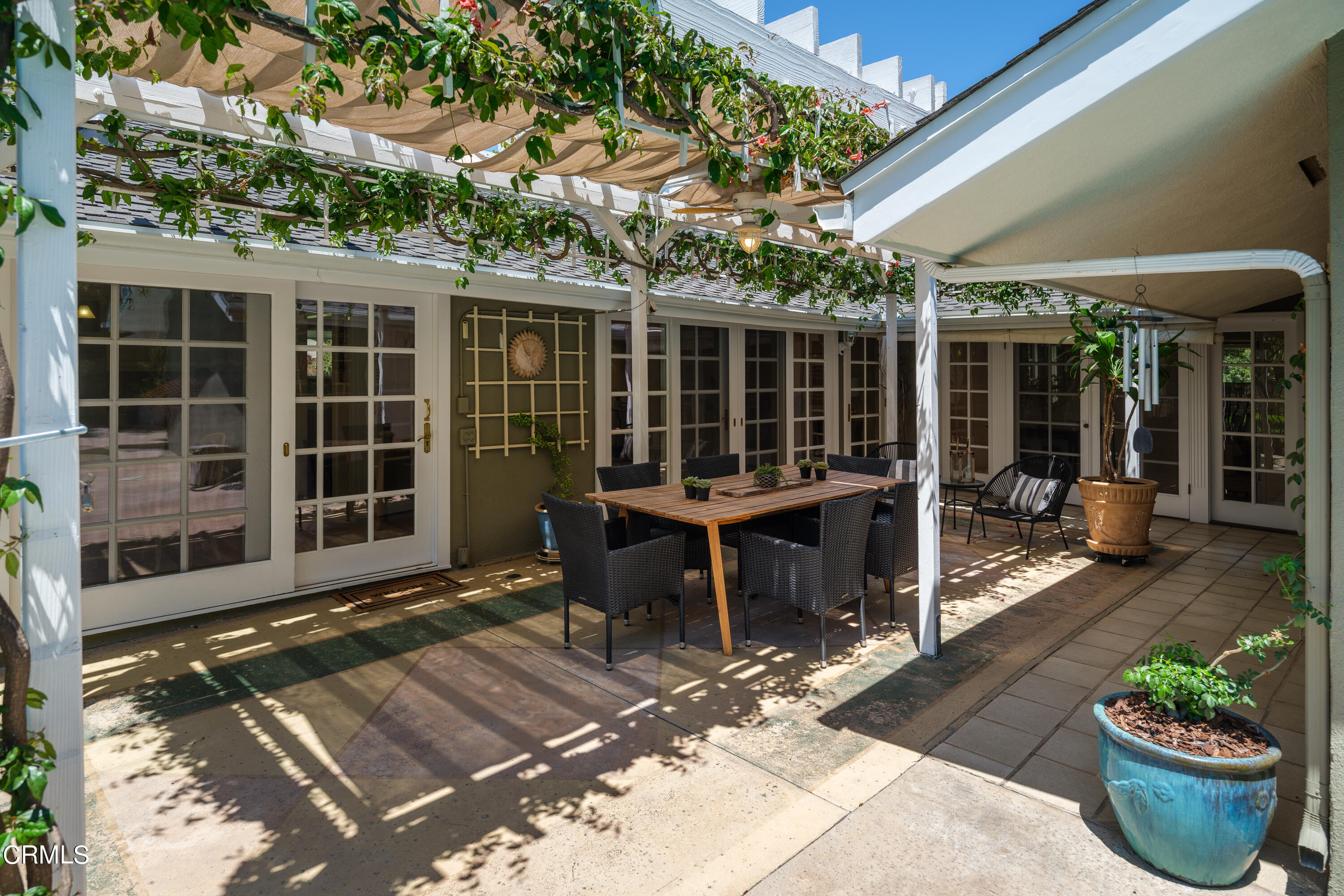 1450 Pegfair Estates Drive Pasadena, CA 91103 - Photo 37 of 58 a view of a patio with table and chairs potted plants and large tree