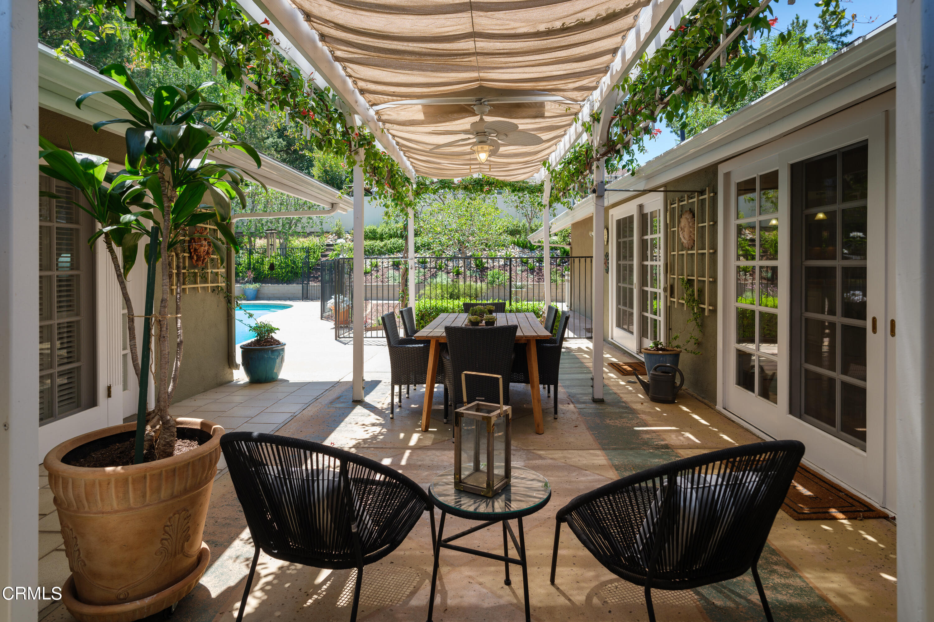 1450 Pegfair Estates Drive Pasadena, CA 91103 - Photo 40 of 58 a view of a patio with table and chairs potted plants and floor to ceiling window