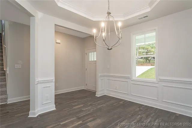 a view of kitchen with kitchen island wooden floor center island and stainless steel appliances