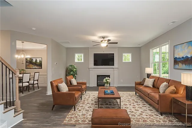 a living room with furniture a fireplace and a flat screen tv
