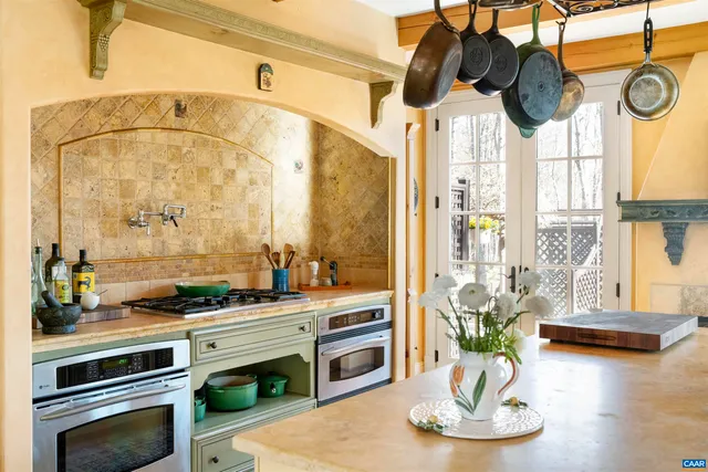 a bedroom with a bed and a dresser next to a window