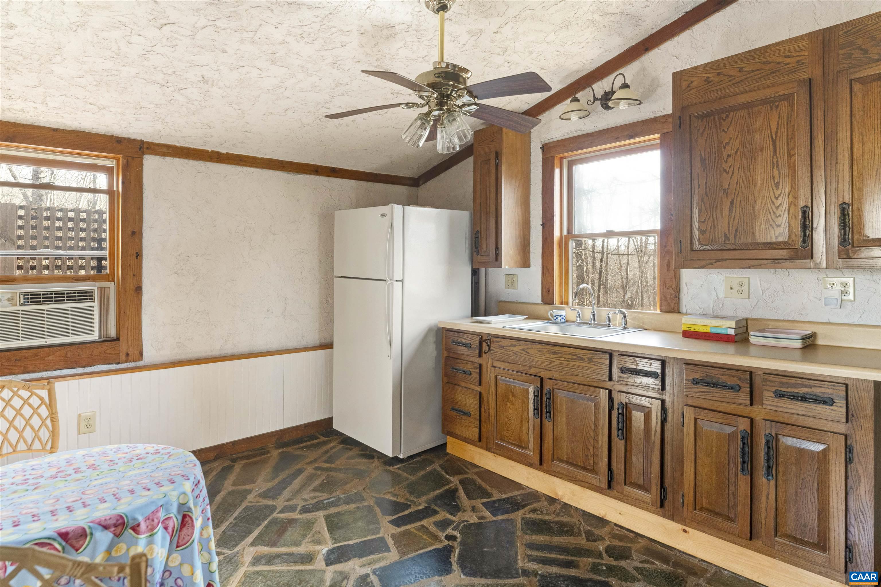 4414 Mt Alto Road Esmont, VA 22937 - Photo 48 of 68 a kitchen with a refrigerator a sink and a window