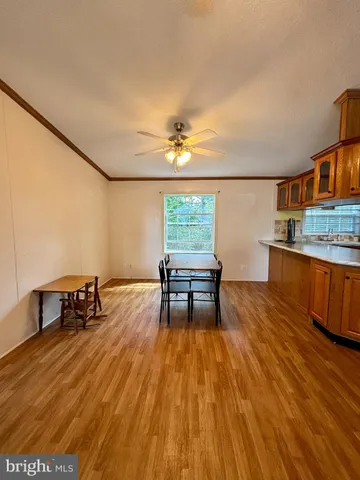 a dining room with furniture and wooden floor