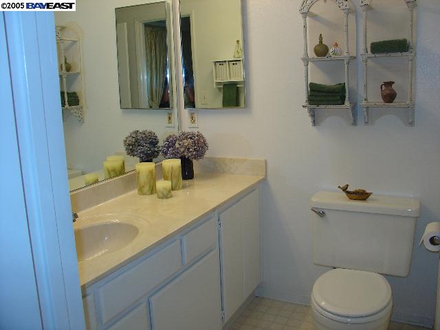 205 A Compton Circle San Ramon, CA 94583 - Photo 5 of 9 a bathroom with a granite countertop sink a toilet and a mirror