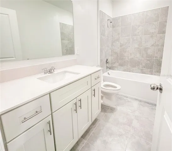 a bathroom with a sink a toilet and a bathtub