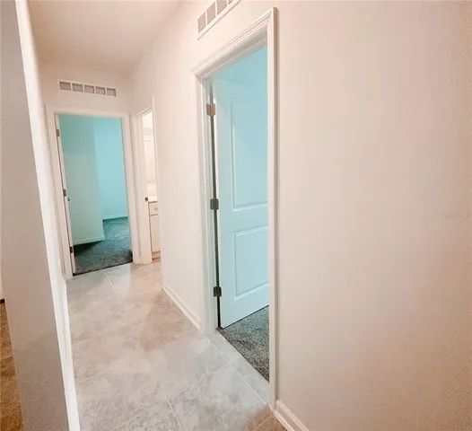 a view of a hallway with closet and utility room