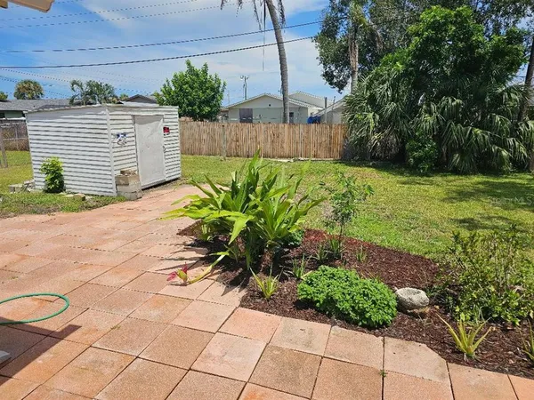 a view of a backyard of the house