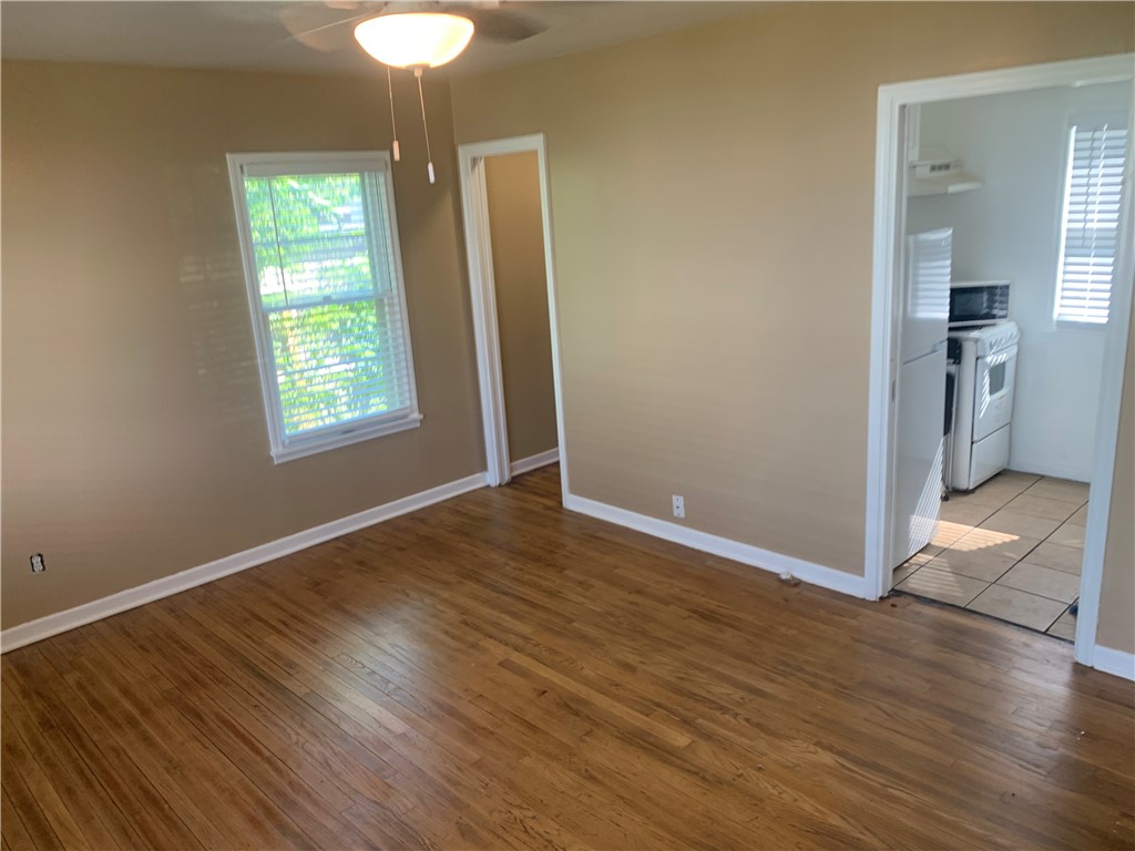 2801 Lawnview Street Corpus Christi, TX 78404 - Photo 4 of 11 an empty room with wooden floor and windows