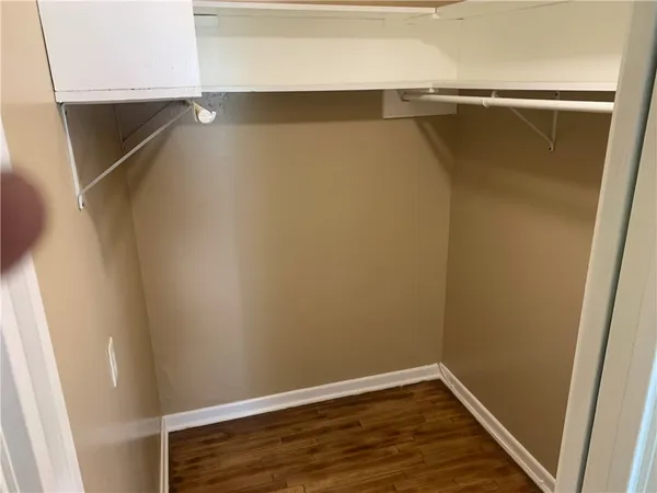a view of walk in closet with empty racks