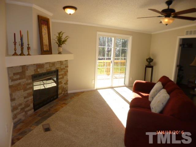 523 Poplar Springs Church Road Raleigh, NC 27603 - Photo 4 of 24 a bedroom with furniture and a fireplace
