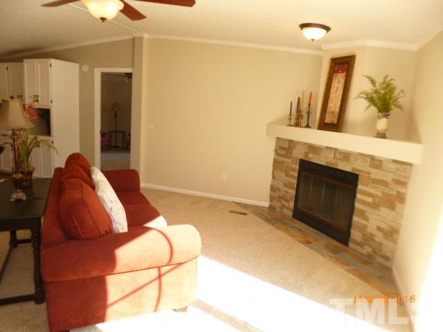 523 Poplar Springs Church Road Raleigh, NC 27603 - Photo 6 of 24 a bedroom with a bed and a fireplace