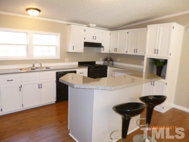 523 Poplar Springs Church Road Raleigh, NC 27603 - Photo 7 of 24 a kitchen with a sink a stove and cabinets
