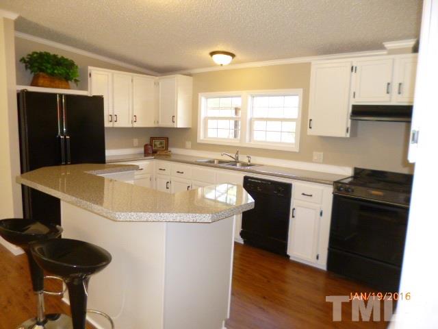 523 Poplar Springs Church Road Raleigh, NC 27603 - Photo 8 of 24 a kitchen with stainless steel appliances granite countertop a sink stove and refrigerator