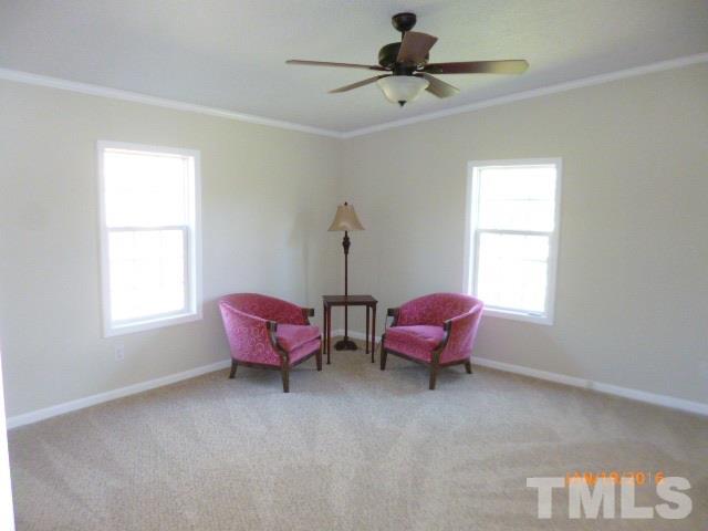 523 Poplar Springs Church Road Raleigh, NC 27603 - Photo 9 of 24 a living room with furniture a window and a chandelier