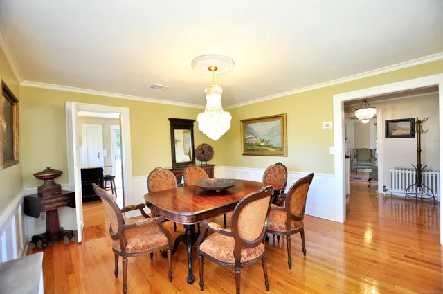 a dining room with furniture and wooden floor