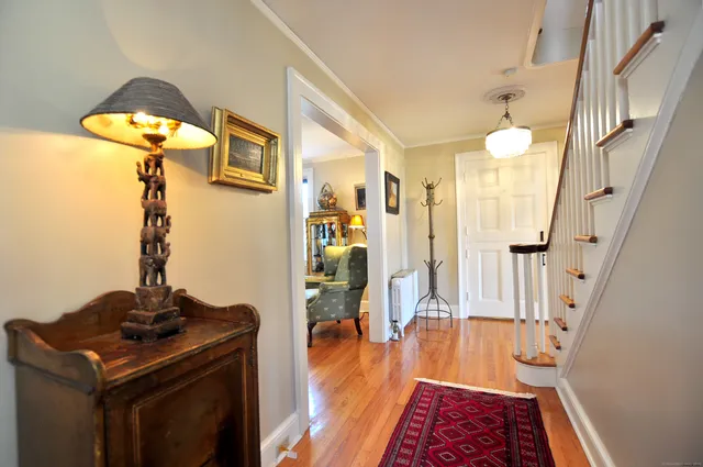 a hallway with a stove and a wooden floor