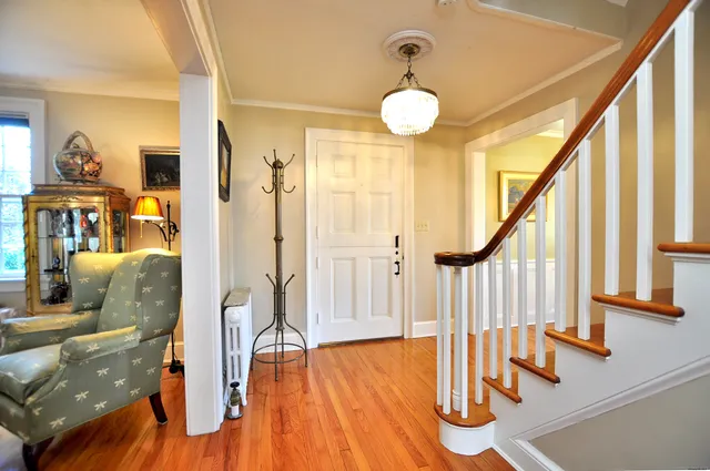 a view of an entryway with wooden floor and door