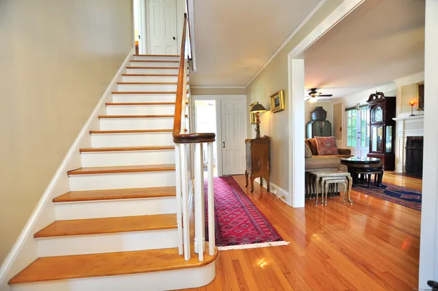a view of entryway and hall with wooden floor