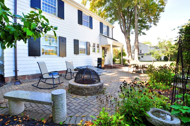 a view of a patio with table and chairs and potted plants