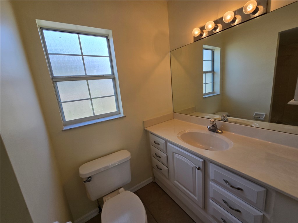 1748 23rd Street Vero Beach, FL 32960 - Photo 10 of 10 a bathroom with a toilet sink and mirror