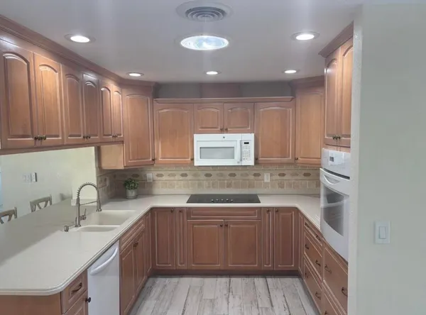 a kitchen with a sink stove and cabinets