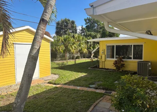 a view of a porch with furniture and a yard