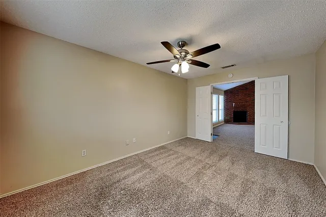 a spacious bathroom with a granite countertop double vanity sink a mirror and a bathtub