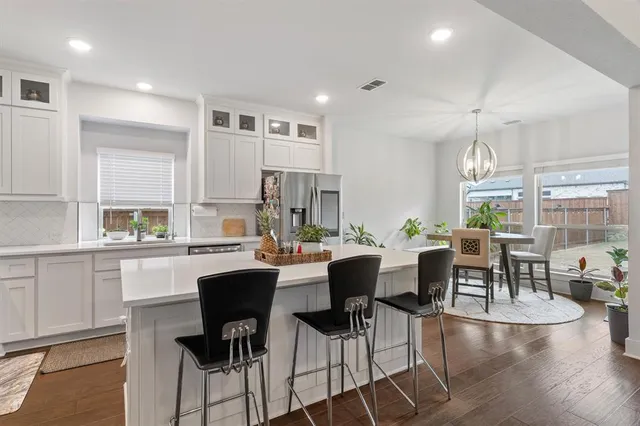 a large kitchen with a table and chairs