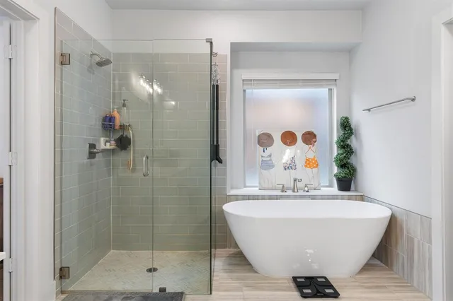 a bathroom with a bathtub and shower