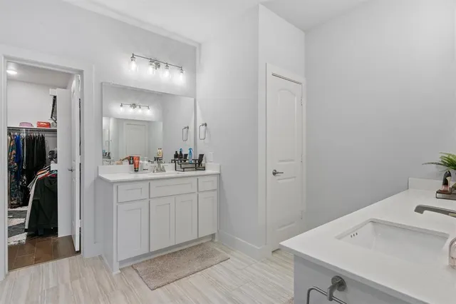 a bathroom with a sink vanity and a mirror