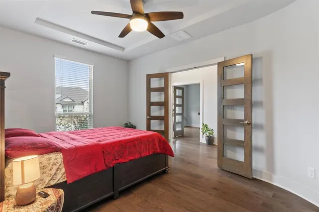 a bedroom with a large bed and a window