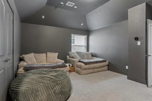 a spacious bedroom with a bed and a window