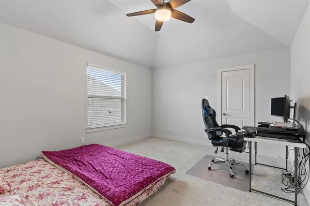 a bedroom with a workspace