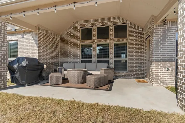 a balcony with furniture and a potted plant