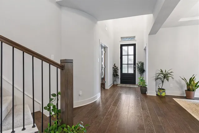 a view of an entryway with wooden floor and door