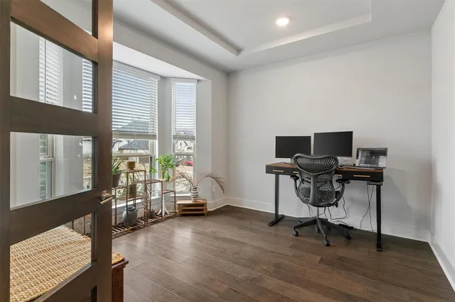 a view of a workspace with furniture and a window
