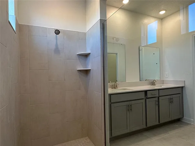 a bathroom with a double vanity sink and mirror
