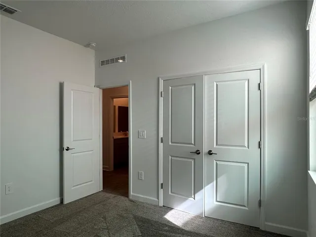an empty room with wooden door