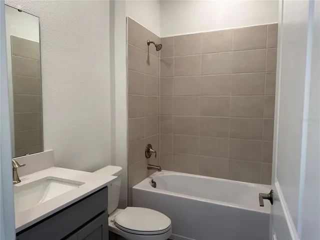 a bathroom with a sink a toilet and bathtub