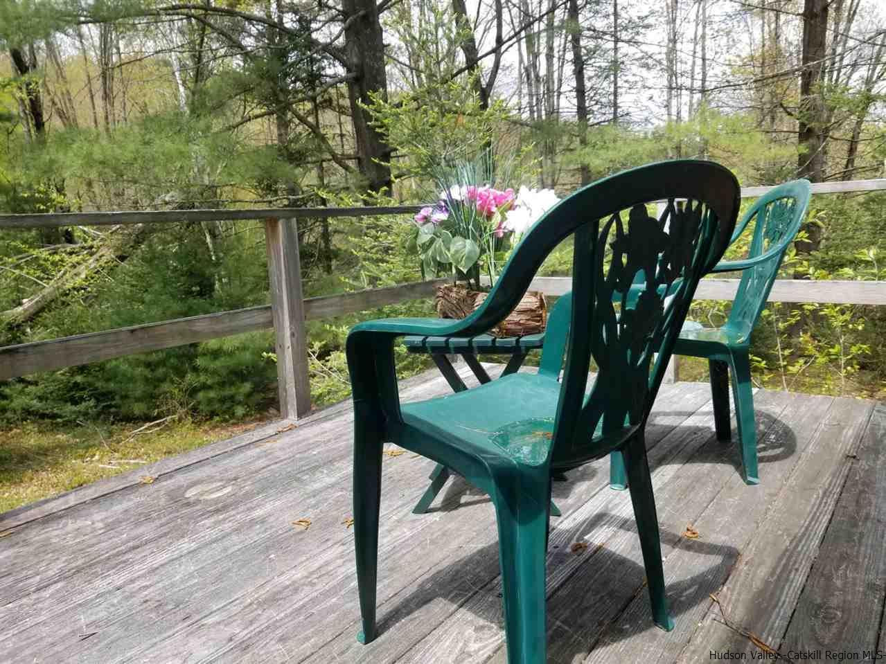 545 Upper Cherrytown Road Kerhonkson, NY 12446 - Photo 11 of 35 a view of a chairs and table in the patio next to a yard
