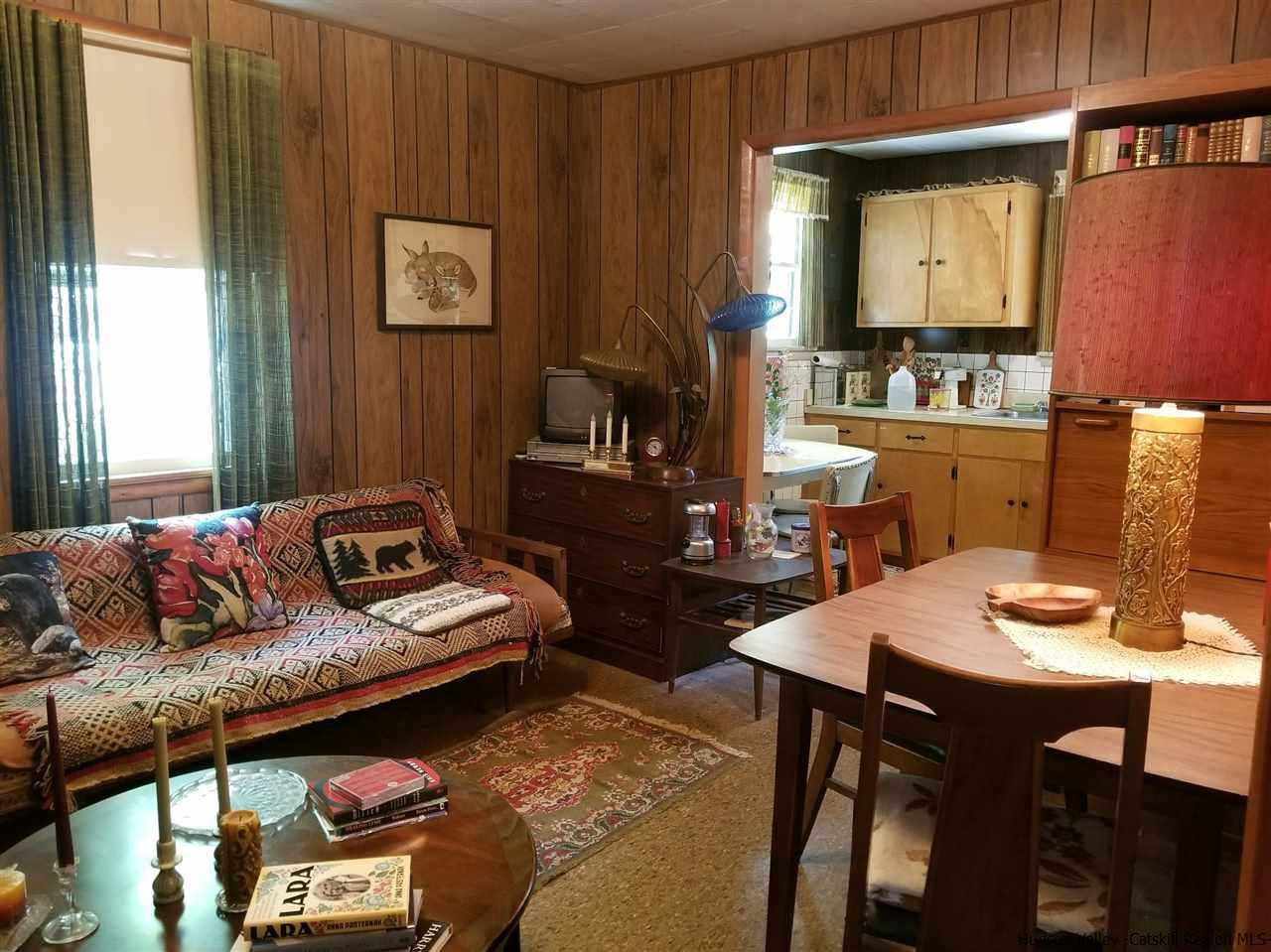 545 Upper Cherrytown Road Kerhonkson, NY 12446 - Photo 14 of 35 a living room with furniture and a table