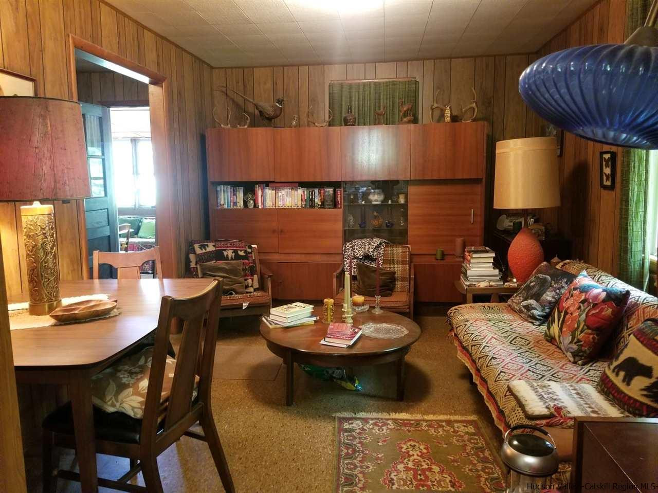 545 Upper Cherrytown Road Kerhonkson, NY 12446 - Photo 20 of 35 a living room with furniture and a table