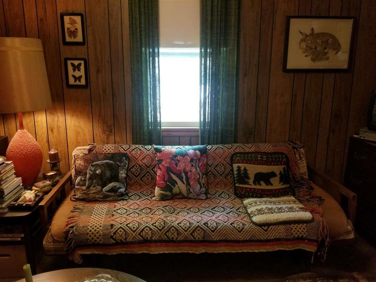 545 Upper Cherrytown Road Kerhonkson, NY 12446 - Photo 22 of 35 a bedroom with a bed and a painting on the wall